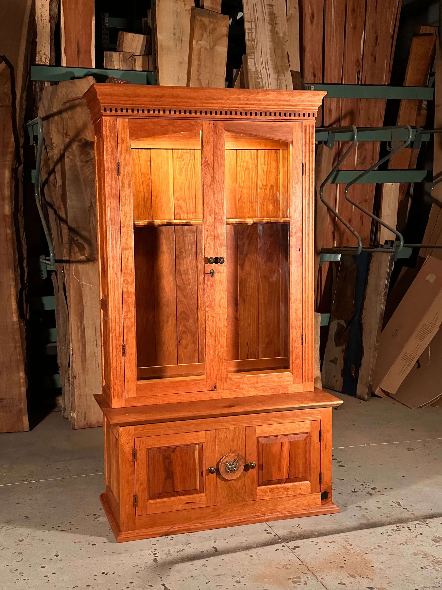 Solid cherry wood gun case with lockable upper and lower cabinets, featuring a secret storage compartment.