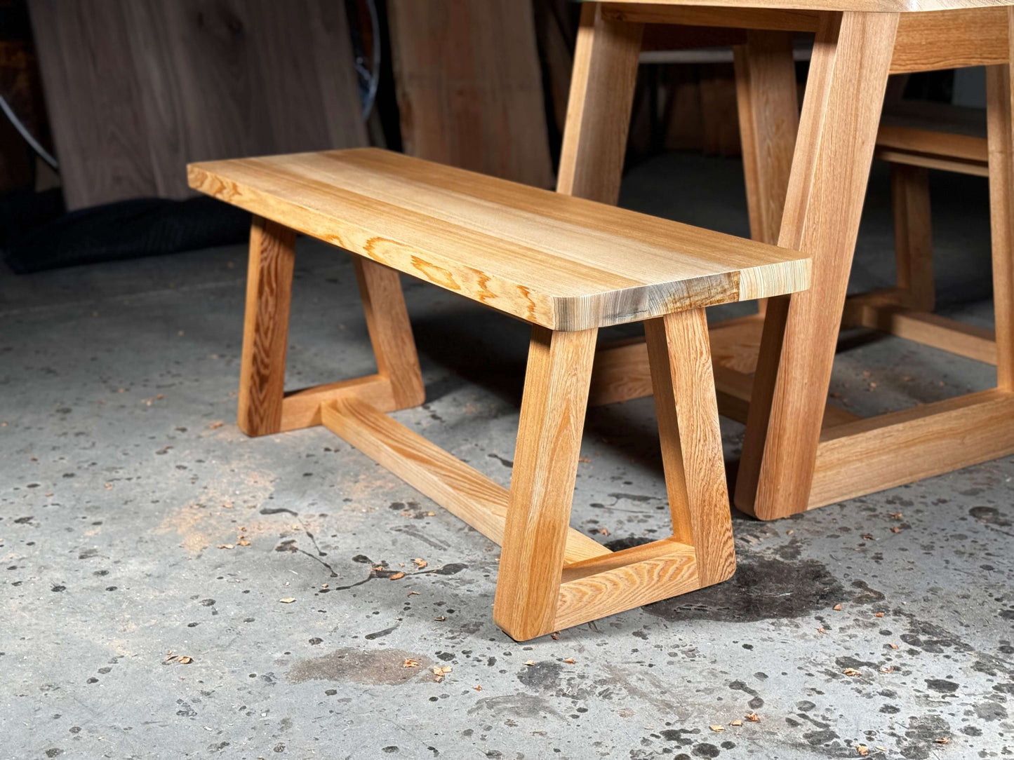 Wooden bench with a modern tapered leg design, perfect for kitchen nooks or patio dining, matches the Newman kitchen table set.
