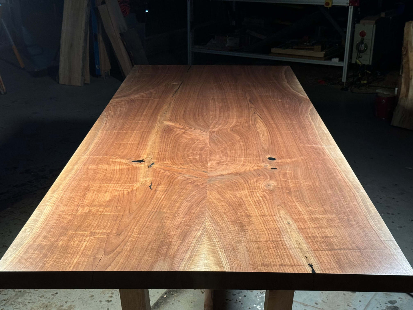 Solid wood dining table with sleek modern design, showcasing smooth textures and rich grain patterns for a sophisticated look.