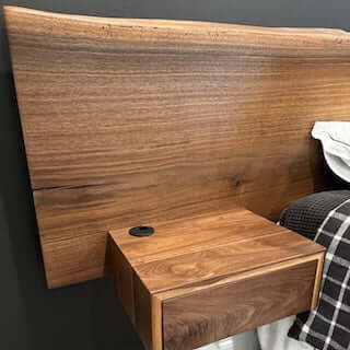 Solid walnut live edge headboard with floating vanity, showcasing rich grain for stylish Airbnb decor.