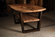 Rustic wooden coffee table with natural wood grain and dark metal frame, featuring a sturdy lower shelf.