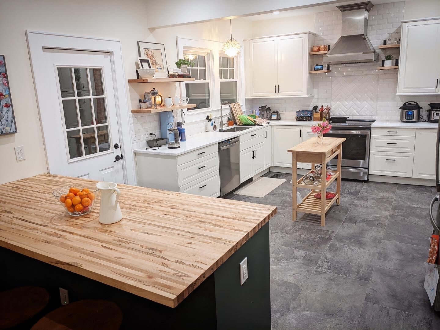 Modern kitchen featuring luxurious butcher block countertops with natural wood finish, enhancing elegance and warmth.