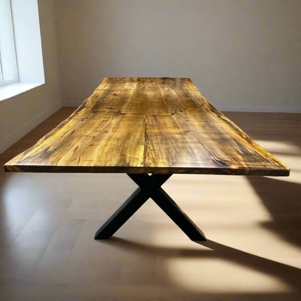 Book-matched live edge table with natural wood grain and metal legs, showcasing seamless symmetry in a well-lit room.