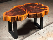Rustic cookie coffee table with unique wood grain patterns and metal legs, perfect for small spaces or cozy coffee settings.