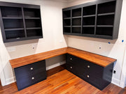 Hardwood countertops with dark cabinetry in a modern office setup showcasing natural wood grain and elegant design.