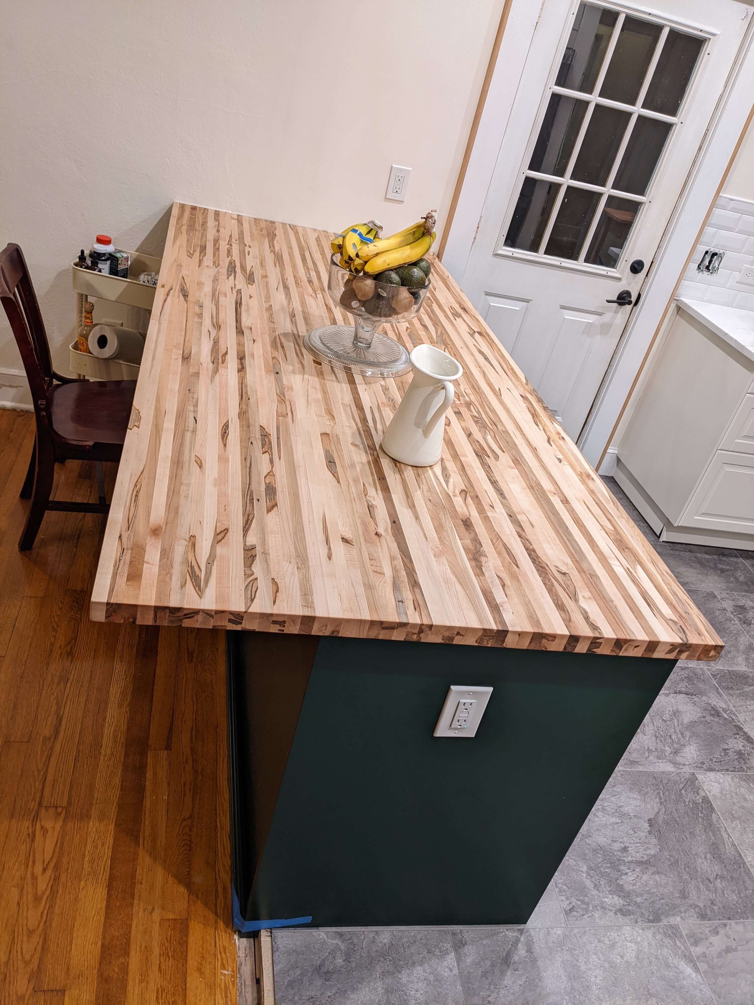 Elegant butcher block countertop in a modern kitchen setup.