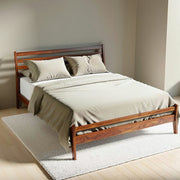 Wooden bed with beige bedding in a minimalistic room