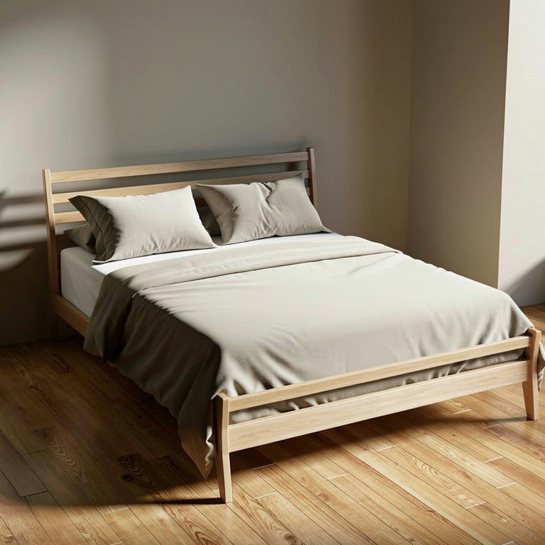 Wooden bed with white bedding in a minimalistic room
