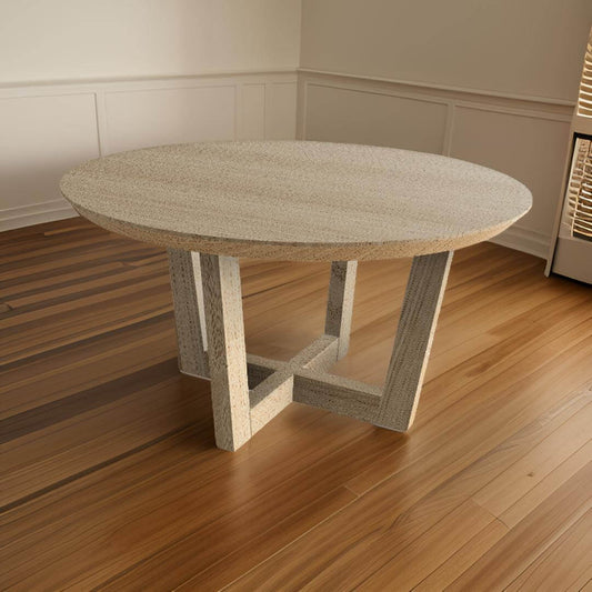 Elegant round dining table with a curved silhouette and detailed craftsmanship on a wooden floor in a modern dining room.