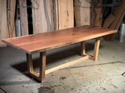 Sleek modern design of The Brooklyn solid wood dining table in a workshop setting, showcasing its simplicity and timeless sophistication.