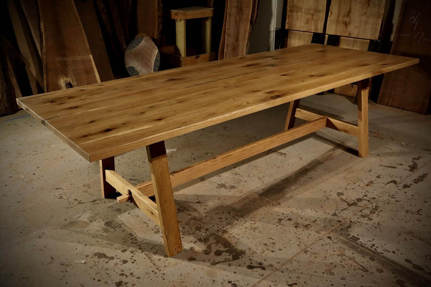 Rustic farmhouse trestle table made of solid wood, showcasing elegance and durability, perfect as a gathering centerpiece.