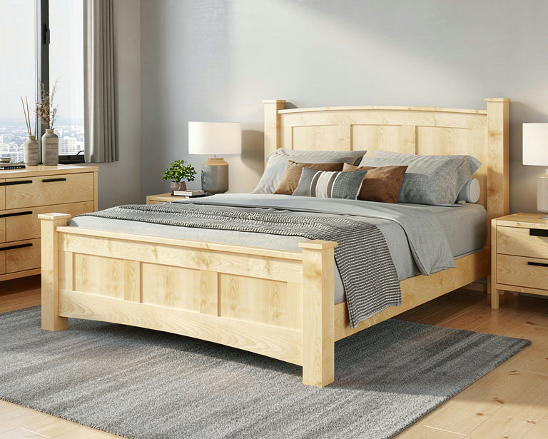 Wooden bed in a bedroom with light gray walls and wooden flooring.
