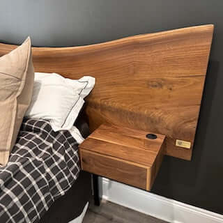 Live edge walnut headboard with floating vanity, showcasing unique wood grain and modern design in an Airbnb bedroom.