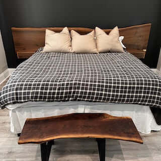 Solid walnut live edge headboard with floating vanities in a stylish Airbnb bedroom setup.