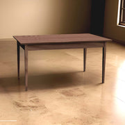 Simple Shaker kitchen table with tapered Hepplewhite legs in a sunlit room, showcasing minimalist design and elegant functionality.